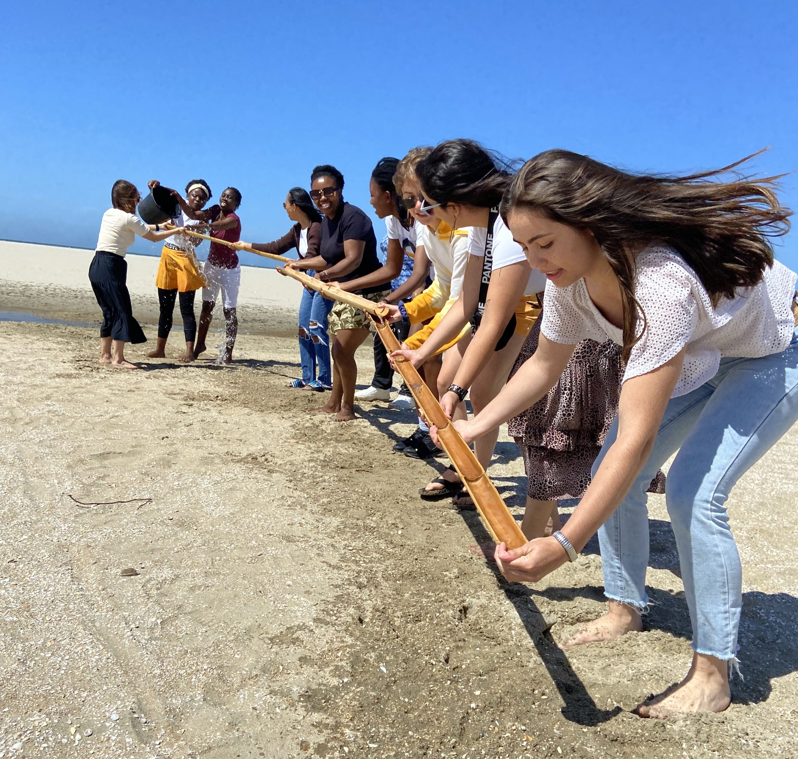 About us and our core values in this picture you see a group of women working together on a beautiful beach on a summers day in the netherlands