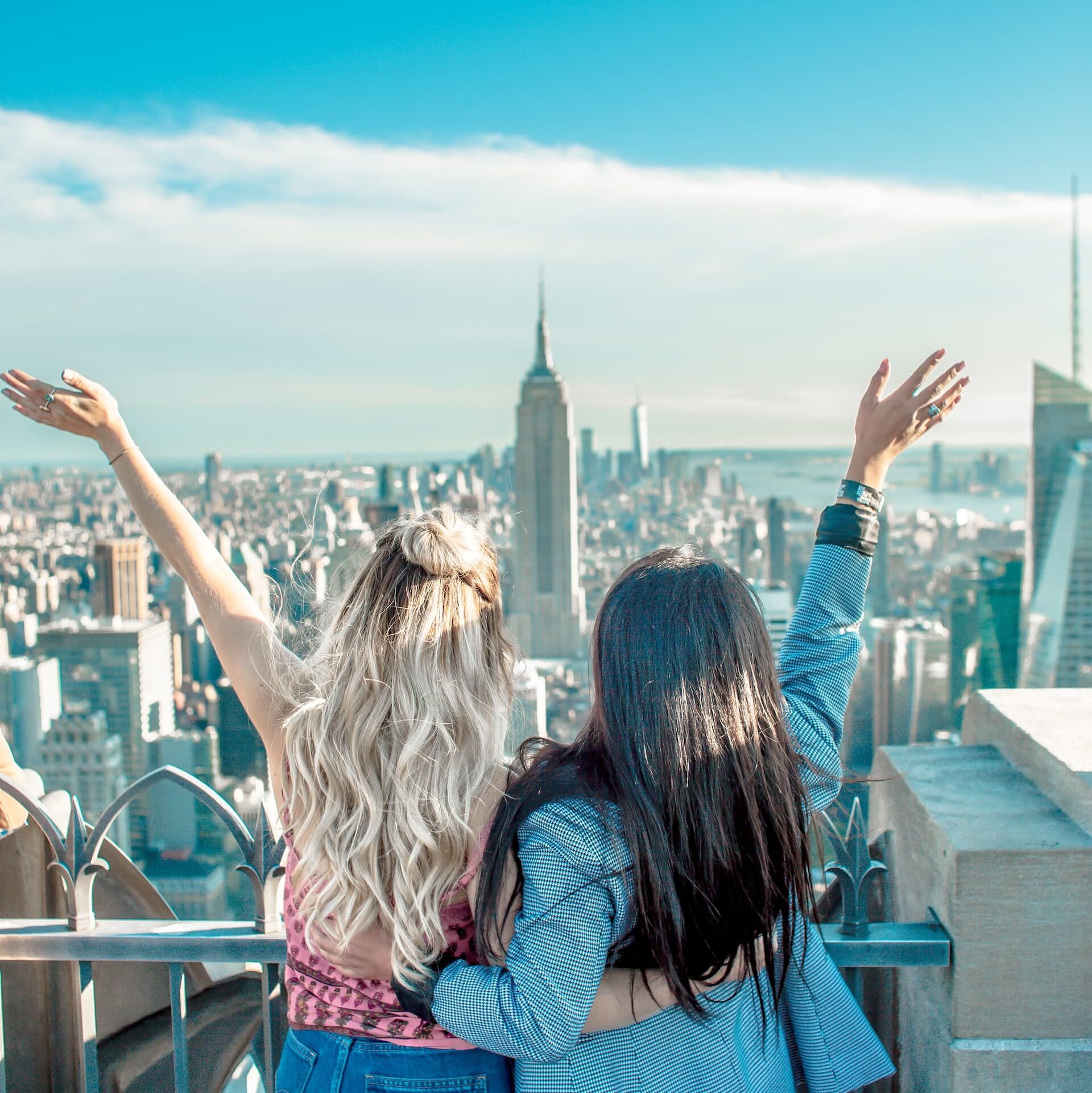 Two au pairs pose in front of the Empire State building in New York City during their au pair stay in America.