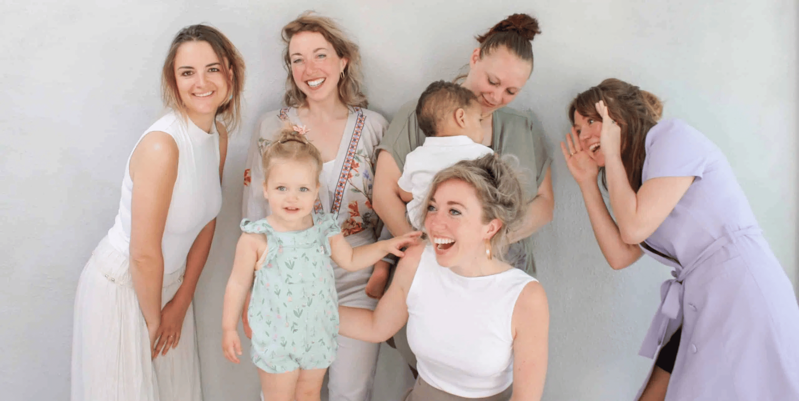 Nina.care babysitters and au pairs are pictured with babysitters on their arms and smiling into the camera