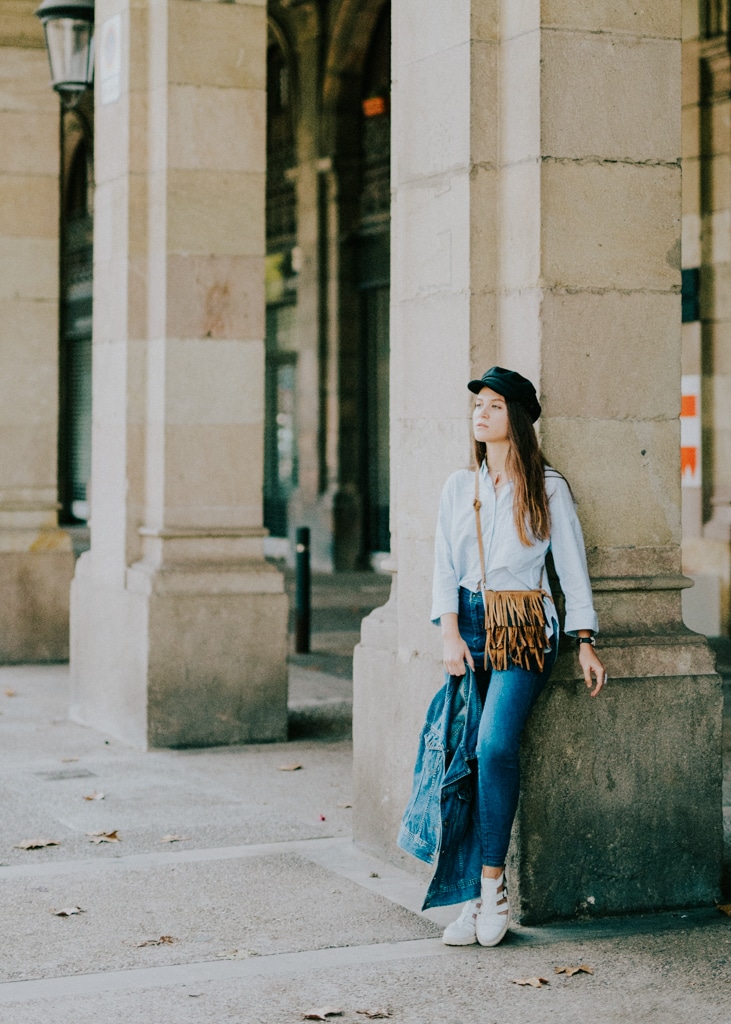 An au pair poses by a beautiful column in an old square in Italy. Conditions to au pair in Italy