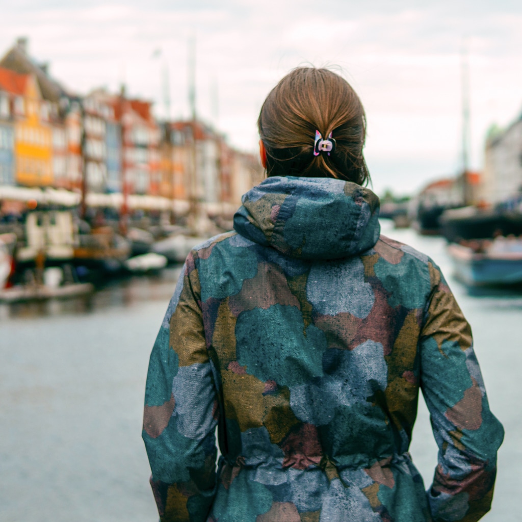 An au pair looks across Nyhavn, a 17th-century waterfront, canal and entertainment district in Copenhagen, Denmark.