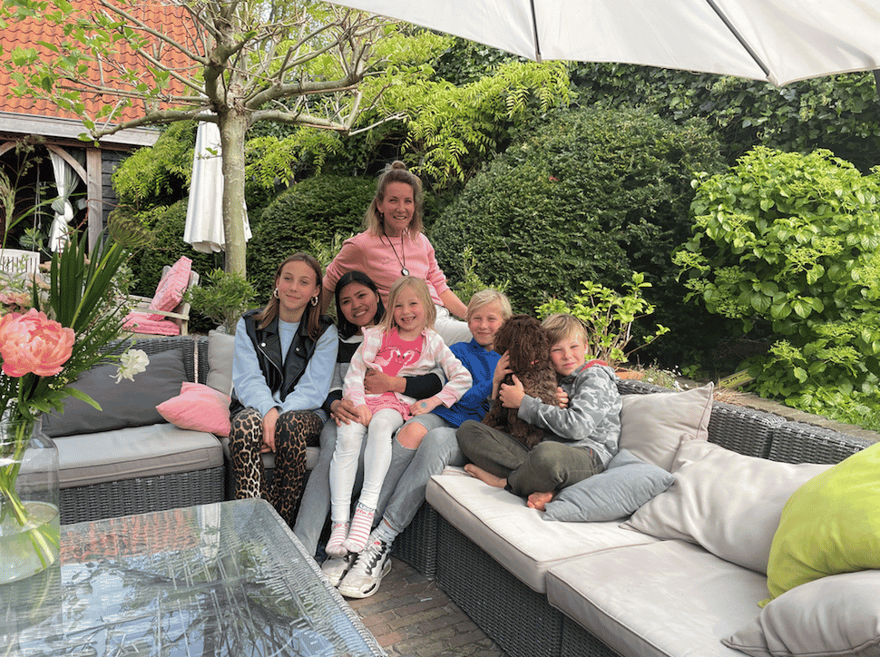 marieke in de tuin samen met haar kinderen en au pair om te vertellen over haar ervaring als host family
