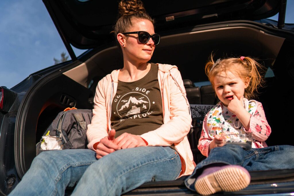 au pair and her host kids in the back of a car on a trip with children