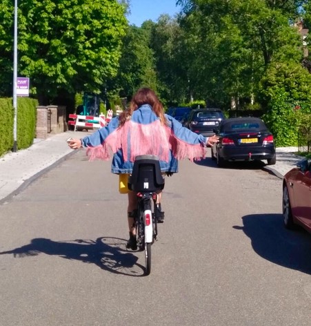 au pair laura in the netherlands on a bike cycling through a neighborhood 