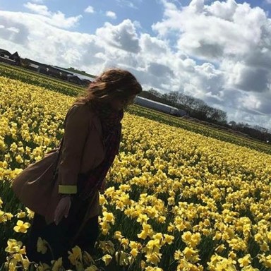 au pair laura in the netherlands standing in a yellow flower field