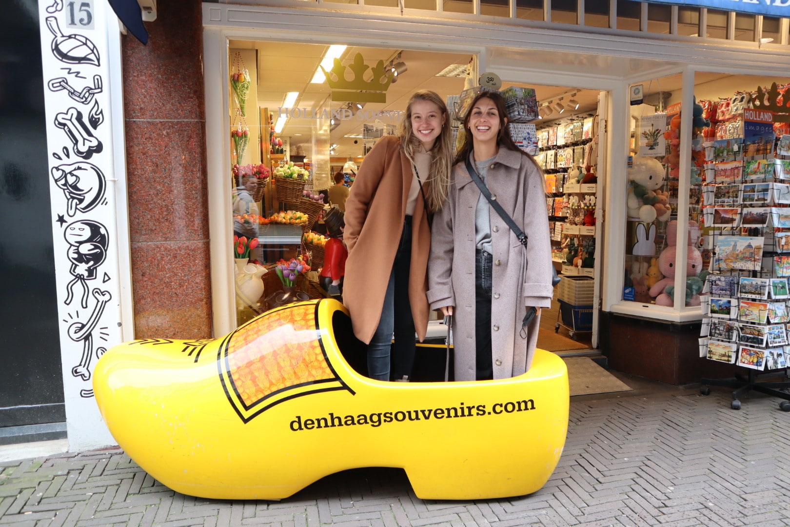 au pair in the netherlands mia is standing on wooden shoes in a shopping street
