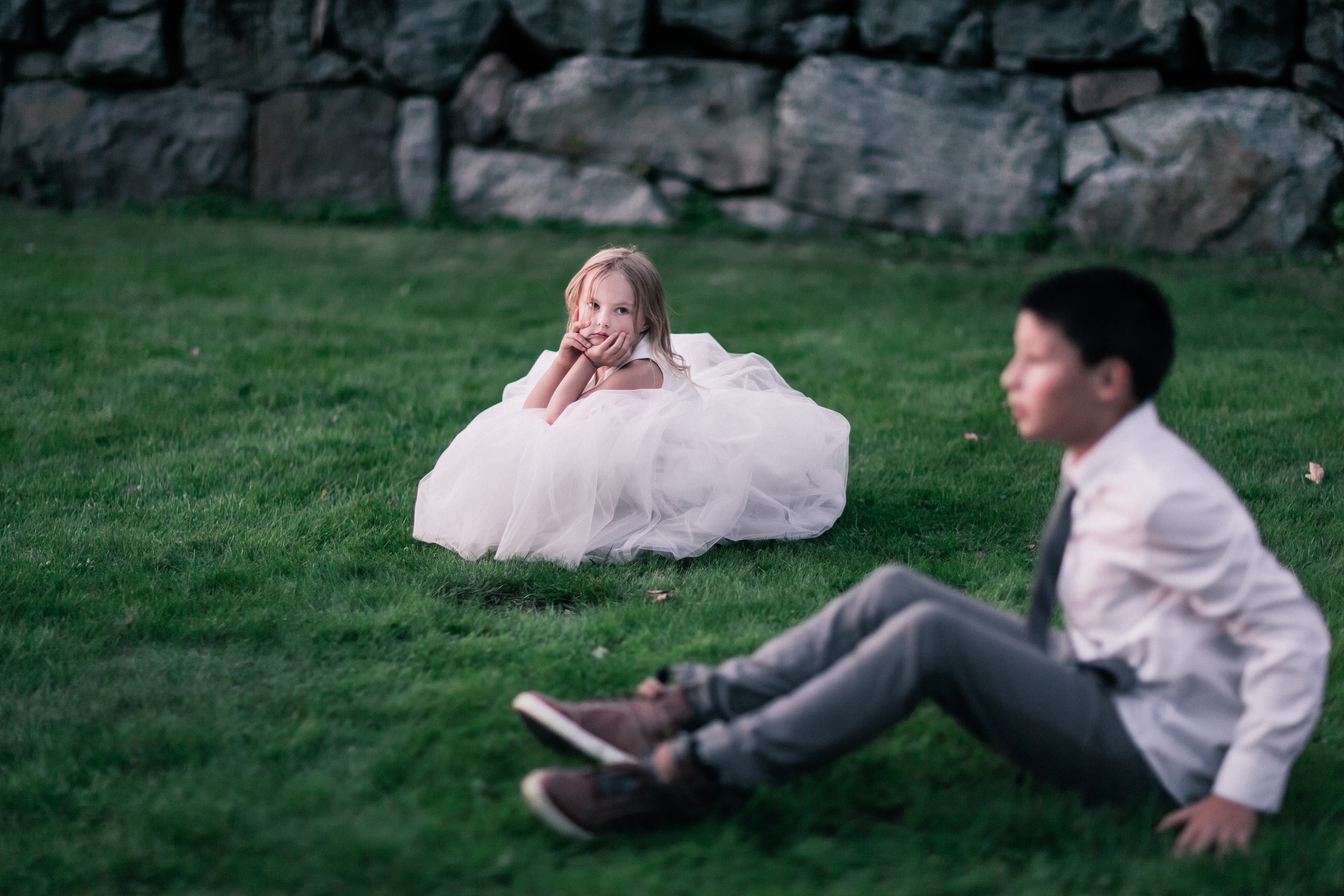 Cute kid looking at a boy in a wedding dress with no event babysitter around