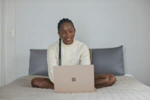 Au pair on her bed creating an introduction video for host family