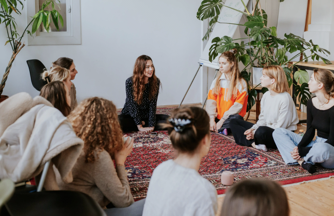 au pair events nina.care with a group of au pairs sitting on the ground in a circle